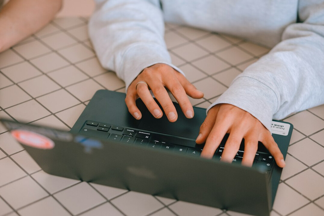 kids coding on laptops