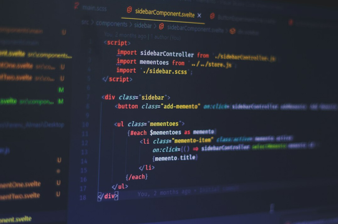 person coding on laptop